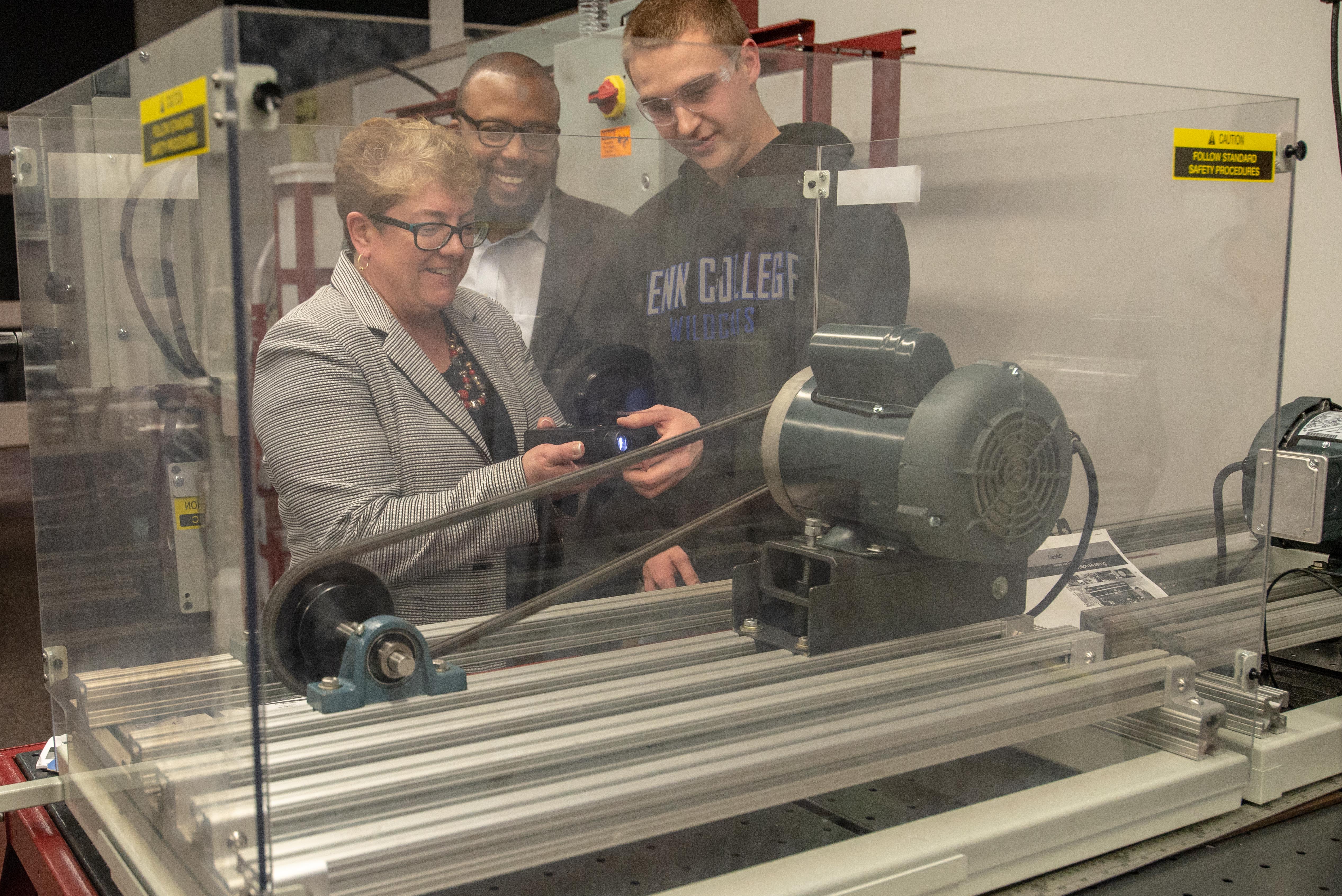 With the help of Jacob M. Endy, of Pottstown, a sophomore in mechatronics engineering technology, Eileen Cipriani, Pennsylvania’s deputy secretary for workforce development, measures rotation speed. They are joined by Eric Ramsay, director of the state’s Apprenticeship and Training Office.