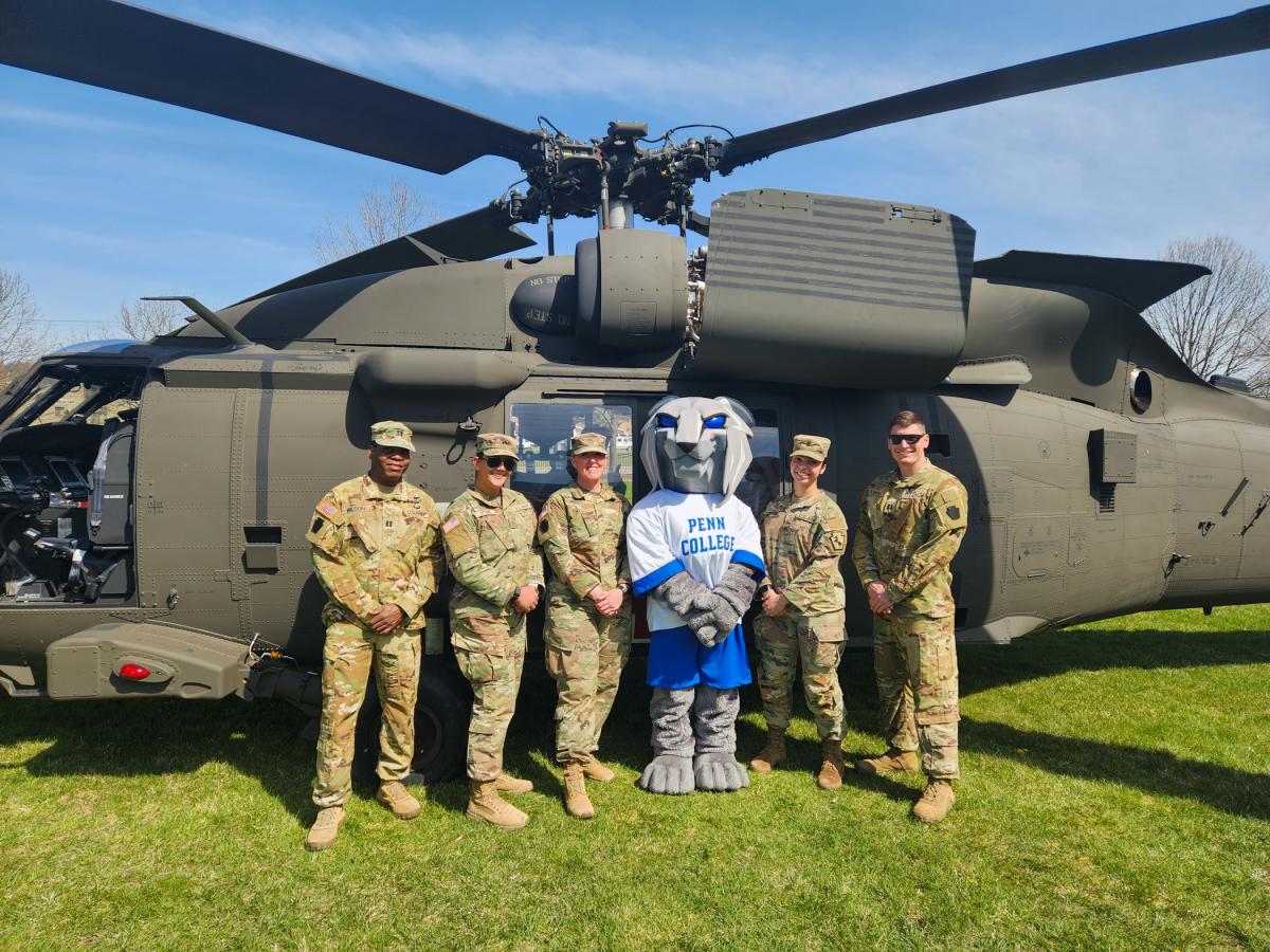 Reporting for duty! The mascot savors a moment in the sun with the Army National Guard.