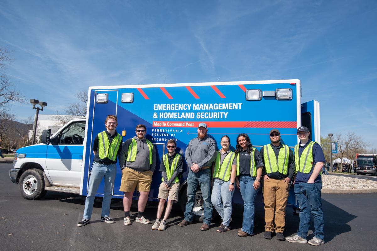 At their new Mobile Command Post, an ambulance donated by Fike Services LLC, a few of the emergency management & homeland security students pause to pose with Logan Fike (at center), owner of the Watsontown business that repairs and services emergency vehicles. 