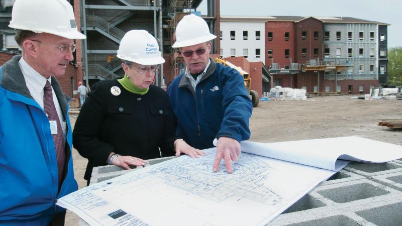 The president reviews plans at the Dauphin Hall construction site in 2010 with since-retired Walter D. Nyman, director of general services, and Andrew M. Richardson, construction manager ...