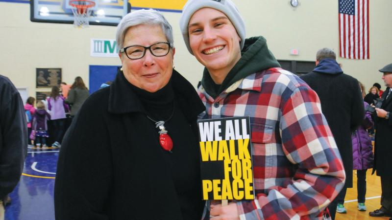 Gilmour connects with student Colin D. McOdrum during a 2017 community peace walk to commemorate Martin Luther King Jr. Day ...